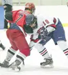 ROBERT DeBERRY/ Frontiersman Wasilla Warrior Trent Wohlers and
Houston Hawk Micah Ranum go shoulder to shoulder during a face off
Wednesday at the Curtis C. Menard II Ice Arena in Wasilla. Th