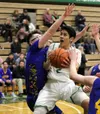 Colony senior Will Freeman tries to split a pair of defenders as he drives to the basket during a win over Kodiak Friday, Jan. 19, 2018, at Colony High School. Freeman moved with his family f