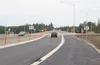 Cars travel along Bogard Road through a newly opened roundabout at the intersection of Bogard and the new Trunk Road extension. Work continues on the extension, which will bring the new Trunk