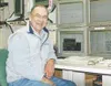 Tom Sokolowski takes one last look at the computer instruments
at the West Coast and Alaska Tsunami Warning Center in Palmer.
After 21 years of being the center's geophysicist, Sokolowski
ret