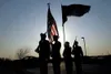 ROBERT DeBERRY/Frontiersman Members of the Army National Guard
Honor Guard are silhouetted against the setting sun as they present
the colors Monday at the first In-Memory Day/Patriots Day ce