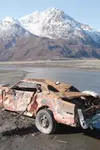An abandoned car sits rusting at Jim Creek with the river and
northeast flank of Pioneer Peak as a backdrop. The Department of
Natural Resources tows out an average of 25 of these cars from t