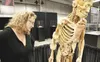 Missy Adzick with the Our Body the Universe Within exhibit takes a closer look at one of the bodies on display during set up Monday afternoon in the Don Sheldon Events Center on the Alaska St