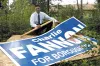 Link Fannon, campaign manager for Mat-Su Borough mayoral
candidate Charlie Fannon, shows one of several signs vandalized
recently. Photo by STEVE KADEL/Frontiersman.
