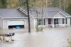 A house on North Marilyn Circle in Wasilla sits in several feet of water Thursday morning. ROBERT DeBERRY/Frontiersman.com