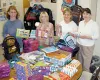 Stacy Clinton, Kelsey Custer, Mary Principe, and Rebecca Custer
ready to stuff donated school supplies at KAP's Wasilla office.
Submitted photo.