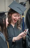 Isabella Sanchez laughs loudly as she and her friend, Madison McDonald, of Wasilla, review the selfies they took before the start of the Friday evening commencement ceremony at Glenn Massay T