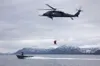 Alaska Air National Guard HH-60G Pave Hawk helicopter aviators assigned to the 210th Rescue Squadron hoist two 212th Rescue Squadron pararescuemen during underway hoist training in the Prince