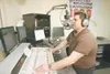 ROBERT DeBERRY/Frontiersman KAYO 100.9 operations manager and
afternoon D.J. Eddie Maxwell works the microphone Thursday at the
station’s new Valley office and broadcast center off the
Palmer