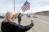 Kathy Hayes holds an American flag as she waves to traffic at the corner of the Parks Highway and Crusey Street during the Conservative Patriots Group Celebrating America event Saturday at Ha