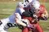 ROBERT DeBERRY/Frontiersman Wasilla’s Cash McGregor pushes for
more yardage as West High’s Jacob Lawrence and Terry Holtman get
the tackle during the Warriors game Saturday at Veteran’s Memor