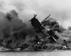 The USS Arizona (BB-39) burning after the Japanese attack on Pearl Harbor, 7 December 1941. The USS Arizona sunk and now rests on the harbor bottom. Over 900 of the 1,177 crew members who die