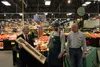 Director of Agriculture for the Department of Natural Resources Dave Schade presents Palmer Fred Meyer produce manager Parker Collins and store manager Dean Forkner with the Golden Carrot Awa