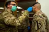 Soldiers stationed at Camp Casey conduct pre-screening processes on individuals awaiting entry to the base in South Korea, Feb. 26, 2020. The Army has rolled out new allowances for Soldiers a
