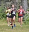 Wasilla's Hailee Giacobbe leads South's Calista Zuber and East's Rosie Conway in the girls varsity race at the Ted McKenney XC Invitational on Saturday, Aug. 23, 2025, at Tsalteshi Trails jus