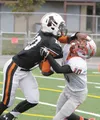 West Anchorage receiver Leroy Elliott tries to push away Wasilla defensive back Caleb Wolfe during a 24-14 loss to the Warriors in Anchorage on Saturday. JEREMIAH BARTZ/Frontiersman