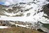 Hikers take in the scenery June 28 at the edge of Gold Cord Lake, a pristine tarn that sits in an alpine bowl at an altitude of just above 4,000 feet in Hatcher Pass’s Independence Mine State