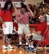 JEREMIAH BARTZ/Frontiersman Jason McCourt and Paul Cossette don
mullet wigs and a pair of shorts to imitate Doug Bean, seated,
during the Region III basketball tournament in March. Bean was
M