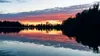 The sun sets behind Reflections Lake in the Palmer Hay Flats State Game Refuge. This Saturday from 11 a.m. to 1 p.m. is the Hike to End Child Sex Trafficking at the lake off the Glenn Highway