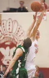 Wasilla senior Connor Devine out-jumps Colony’s Nate Umbarger during Saturday’s title game at the Northern Lights Conference Championships at Wasilla High School. The 6-foot-10 Division I-bou