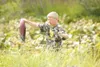 ROBERT DeBERRY/Frontiersman Tim Wood, 14, walks through the tall
grass along the edge of Cottonwood Creek carrying a red that he
caught during the summer of 2007. Mat-Su sockeye returns have
