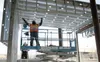 Phaniel Olibrice with Sumner Electric installs wiring conduit in the new Wasilla Public Library Jan. 25. The building is expected to be finished by mid-summer, with an official opening set fo