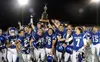 The Palmer Moose hoist the Mayor's Cup as they celebrate a 27-26 overtime victory over rival Wasilla in the 2017 Potato Bowl Friday, Sept. 29, 2017, at Palmer High School. Courtesy of Bruce E