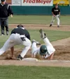 Mat-Su centerfielder Chris Errecart slides back into first base
safely during the first inning of the Miners' 6-5 loss to Stockton
at Hermon Brothers Field on Wednesday. Photo by JEREMIAH BAR