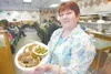 Mat-Su family Restauraunt owner Zina Egbert holds a hot roast
beef plate.