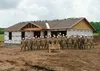 Alaska Air National Guardsmen with the 176th Civil Engineer Squadron stand alongside Brig. Gen. Anthony Stratton, 176th Wing commander, as they near the end of their participation in the Cher