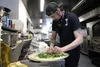 Pizza cook Thad Phillips busily prepped pizza in the kitchen Palmer Alehouse, tossing herbs, cheese and other toppings on a pizza before stuffing it into the oven Jacob Mann/Frontiersman