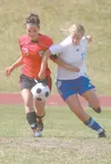 Kenai junior Casey Coupchiak, left, and Palmer senior Juliana
Mangelsdorf fight for position on the ball during the first half of
Kenai’s 2-0 win over the Moose in the first round of the Nort