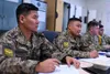 Mongolian Air Force Senior Master Sgt. Purevsuren Bayarmagnai and Chief Master Sgt. Erdenetsogt Aribunold listens during a briefing at the Elmendorf Non-commissioned Officer Academy on Joint 