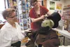 Kellie Coulson and Jessa Joehnk dress a stuffed bear to resemble Abraham Lincoln at Fireside Books in Palmer Thursday afternoon. The Palmer book store is having Abraham Lincoln and Mary Todd 