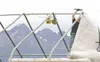 ROBERT DeBERRY/Frontiersman The steel skeleton of the Outdoors
&amp; More booth provides a frame for the peaks of the Chugach
Range as Jerry Holbrook attaches the roof Thursday at the Alaska
