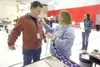 Election worker Marli Holden puts a 'I Voted Today' sticker on
Valley resident Brad Hall Tuesday evening at Larson Elementary.
(ROBERT DeBERRY/Frontiersman)