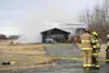 Palmer firefighters work to control a blaze that gutted a house on Badger Road about noon Friday. The fire began in the garage, which was fully engulfed when firefighters arrived. Brian O'Con