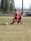 Wasilla's Loren Smith fights through a slide tackle during the
Warriors' win over Ketchikan recently. Smith scored a pair of goals
against on Monday to help Wasilla defeat Colony. With the wi