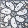 Valley Arts Alliance President Carmen Summerfield created this oyster-shell daisy mosaic for the 'Pieces and Perennials' project installed in the Sutton Public Library and Community Resource 