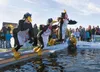 Mat-Su Health Foundation’s Megan Farrell, Kathryn Hahne and Katherine Foster-Dalmolin jump into the cold water of Wasilla Lake dressed as penguins during the 2012 Mat-Su Polar Plunge. Robert 