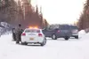 An Alaska State Trooper readies his weapon during a standoff
last month on Wolverine Road. Troopers with assault rifles
surrounded the home in a subdivision north of Bogard Road and east
of S