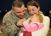 SPANGDAHLEM AIR BASE, Germany -- Staff Sgt. Timothy Raso, 52nd Medical Operations Squadron, embraces his wife, Kristy, and daughter, Aaryanna, at the 22nd Fighter Squadron redeployment party 