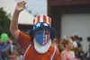 A masked parade participant with the Steven Menard campaign parade float waves to the crowd Monday during the Fourth of July parade. BRIAN O’CONNOR/Frontiersman.com