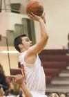 Houston senior forward Charlie Buzby shoots for two points during the Hawks’ double overtime 79-77 win over the Hutchison Hawks Thursday at Houston High School. ROBERT DeBERRY/Frontiersman.co