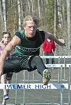 Colony senior Justin Schwartzbauer clears a hurdle during the
second day of competition of the Wasilla High School Invitational
Track and Field Meet at WHS on Saturday. Schwartzbauer blew pas