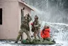 Alaska Air National Guard pararescuemen with the 212th Rescue Squadron prepare to hoist a simulated victim to an awaiting helicopter while participating in a mass-casualty training event at J