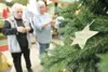 ROBERT DeBERRY/Frontiersman A gold star representing the passing
of Birdie Jean Allen hangs on the Light Up A Life Rememberance Tree
inside Meta Rose Square as Helen Munoz and Sharon Seagondo