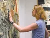 A blind woman uses her hand to ‘see’ the texture of a painting in the film ‘Going Blind, Coming Out of the Dark About Vision Loss.’ Courtesy photo