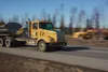 A Knik Construction dump truck rumbles down the Parks Highway last spring. The Alaska Department of Transportation and Public Facilities has announced changes in state-maintained central regi