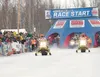 Spectators line the starting chute of the 2010 Iron Dog on Big Lake as Team CC Ski-Doo racers Tyson Johnson and Tyler Aklestad leave the starting line in the 2,000-mile race to Nome then to F